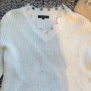 Distressed white sweater